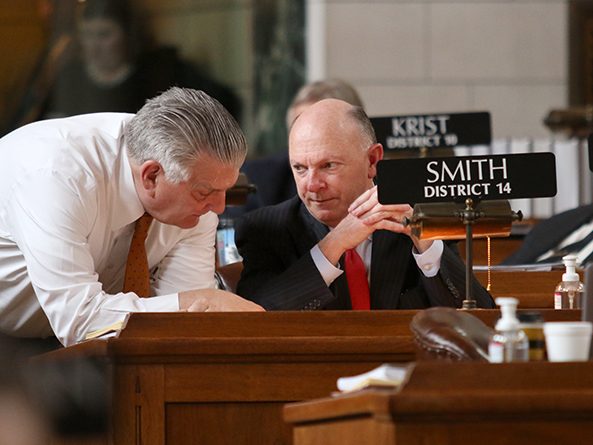 Revenue Committee chairperson Sen. Jim Smith (right), sponsor of LB461, confers with Sen. John Stinner, Appropriations Committee chairperson, during floor debate April 21.